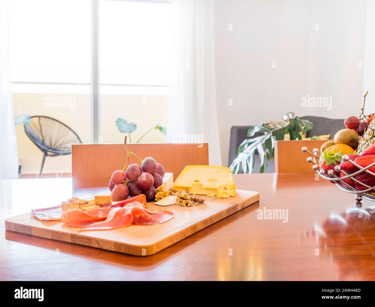 Table with fruit and food in a stylish bright living room with sofa ...
