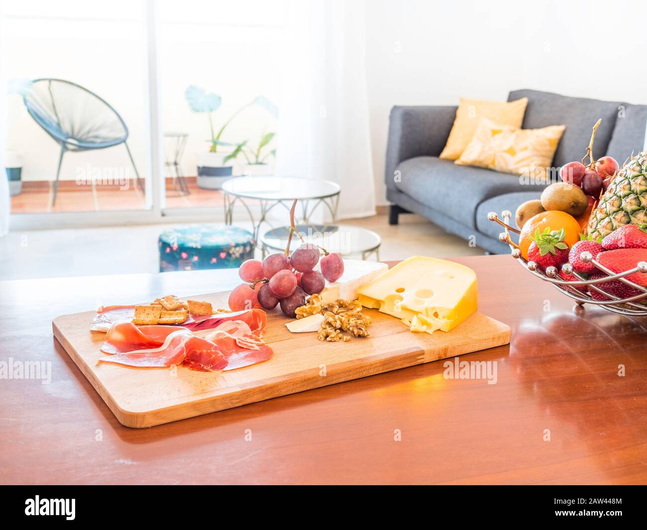 Table with fruit and food in a stylish bright living room with sofa ...
