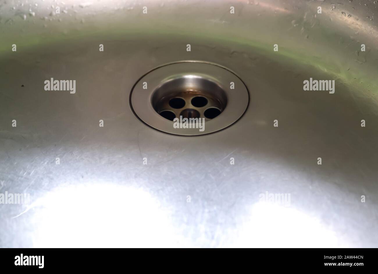 Running water out of a water tap in a metallic kitchen sink Stock Photo ...