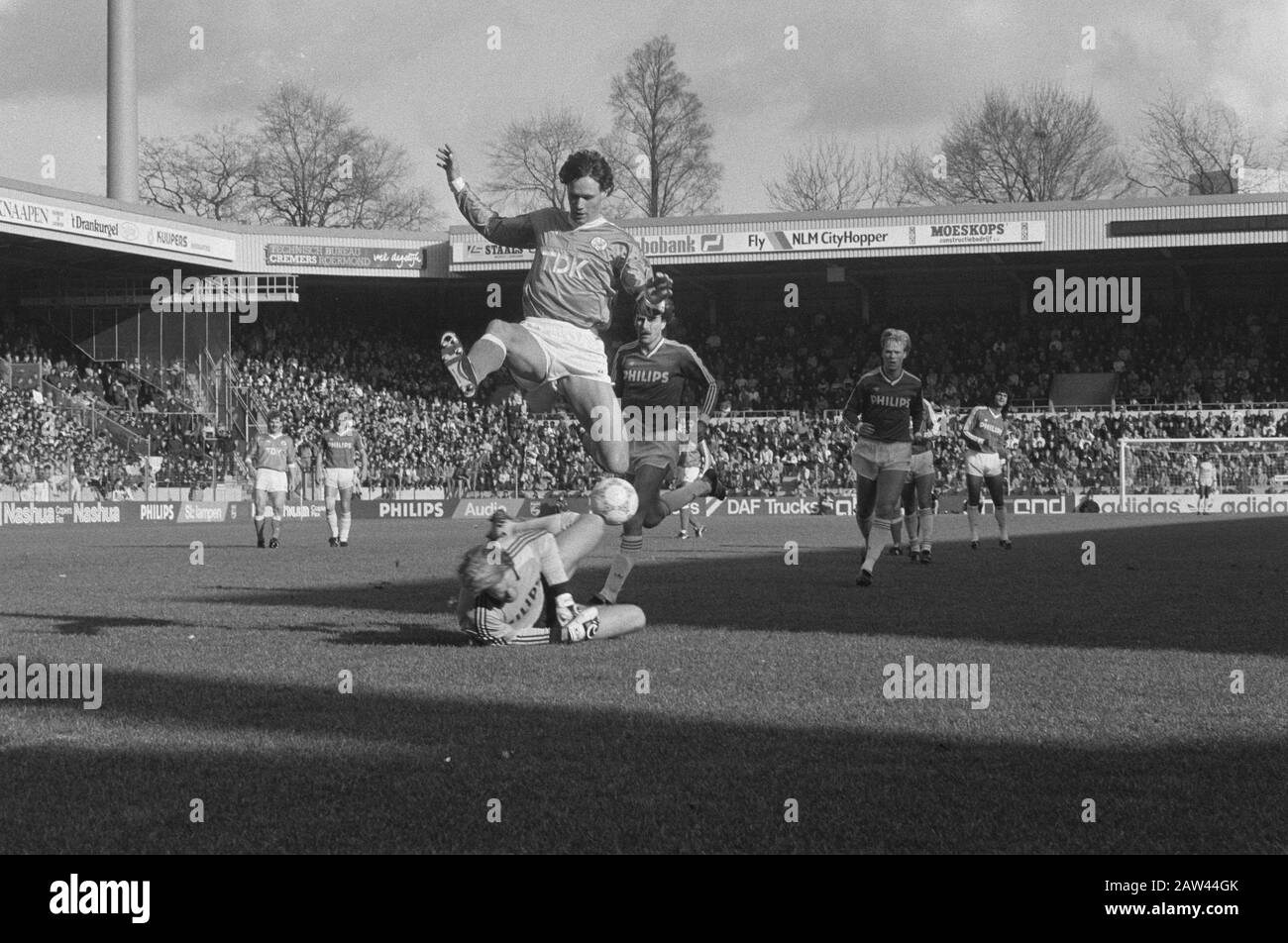 PSV against Ajax 1-0; Van Basten jumps over goalkeeper Van Breukelen Date: March 29, 1987 Keywords: goalies, sports, football Person Name: Basten, Marco van Stock Photo