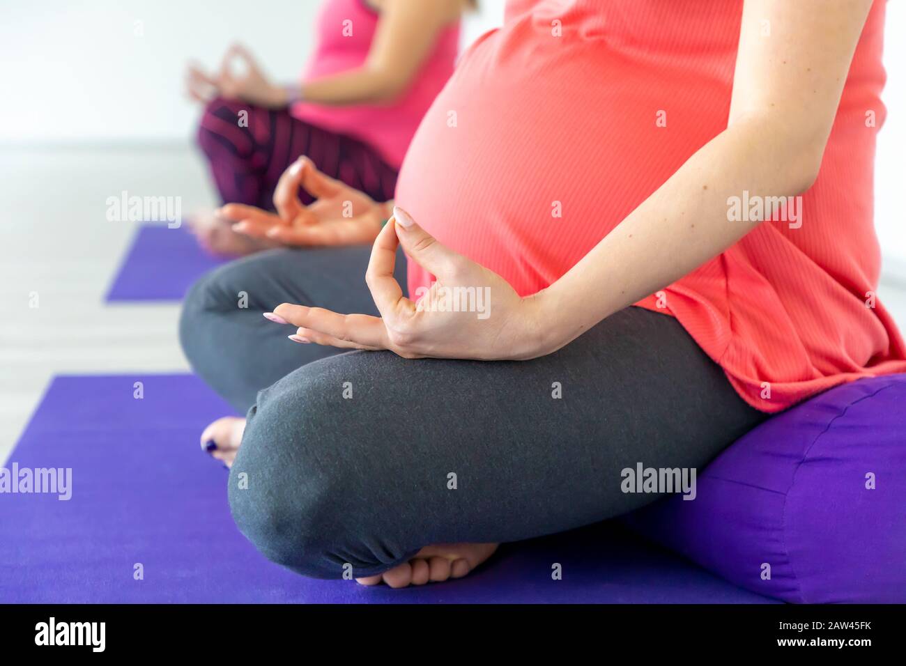 Pregnant women are doing yoga and maditition in yoga class, Healthy prenatal lifestyle Stock Photo