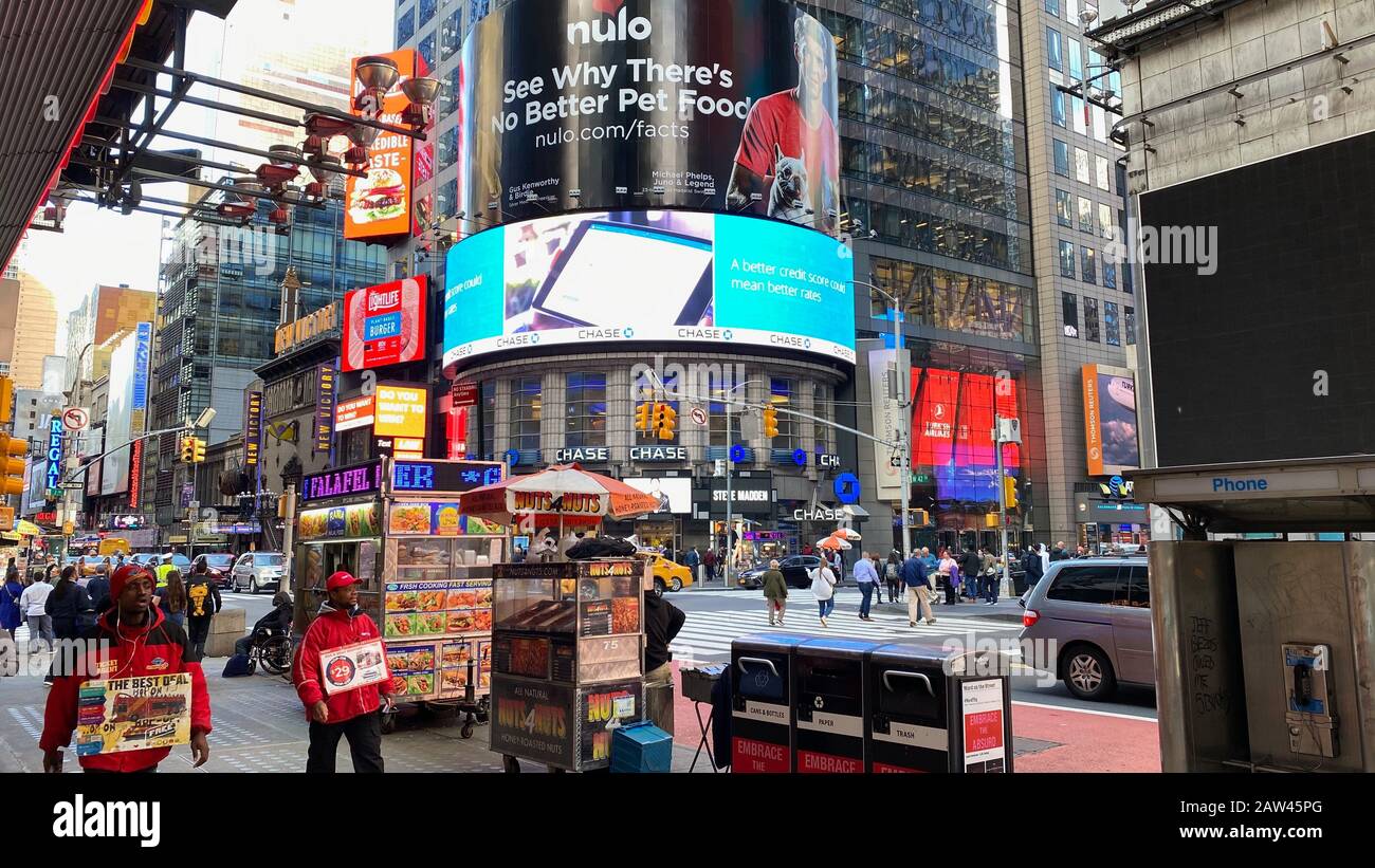 People and signs at a busy corner at Times Square Stock Photo Alamy