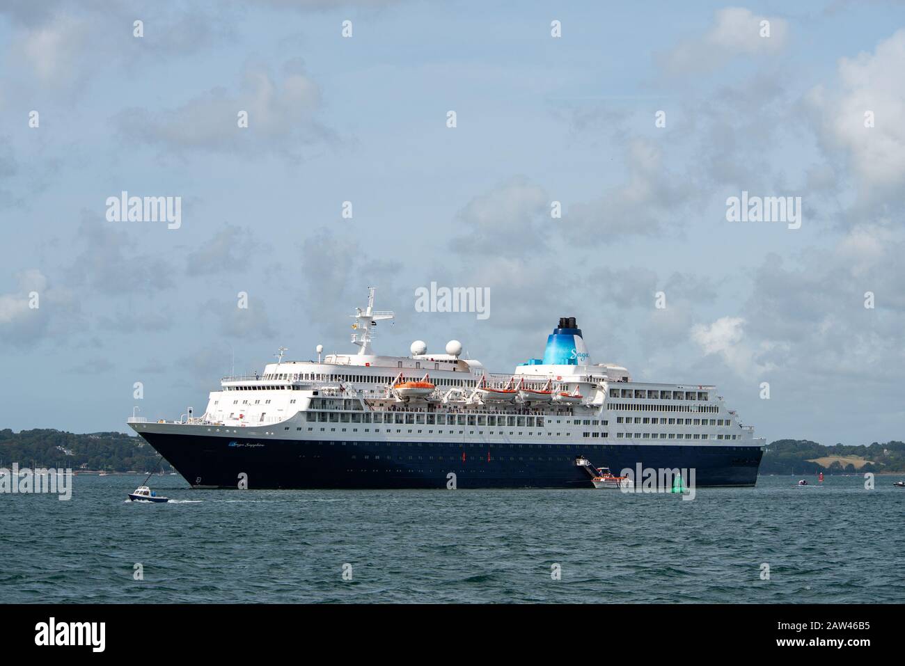Massive Saga cruise liner in Falmouth harbour waters with little boats