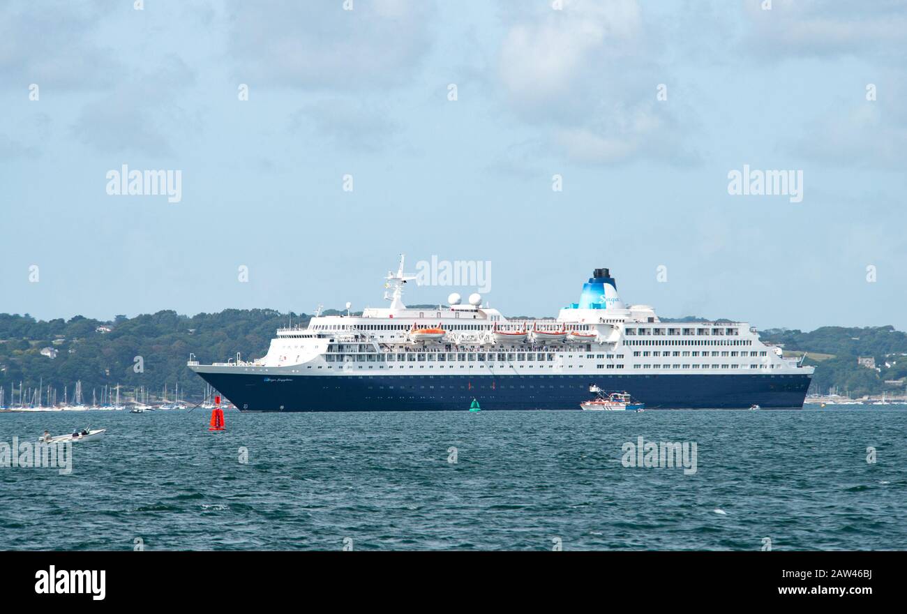 Massive Saga cruise liner in Falmouth harbour waters with little boats