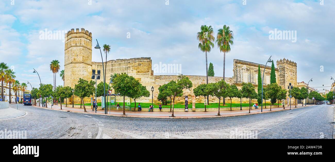 JEREZ, SPAIN - SEPTEMBER 20, 2019: Panorama of medieval Alcazar fortress, extant since the Moorish times, it boasts tall towers, stone ramparts, gates Stock Photo