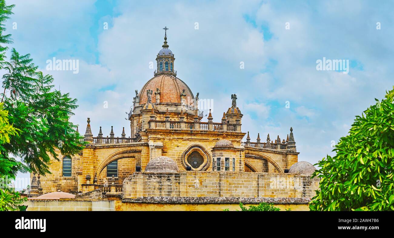 Magnificent medieval dome of Incarnation Cathedral, decorated with stone statues of the saints, geometric tile pattern, carved balusters and massive b Stock Photo