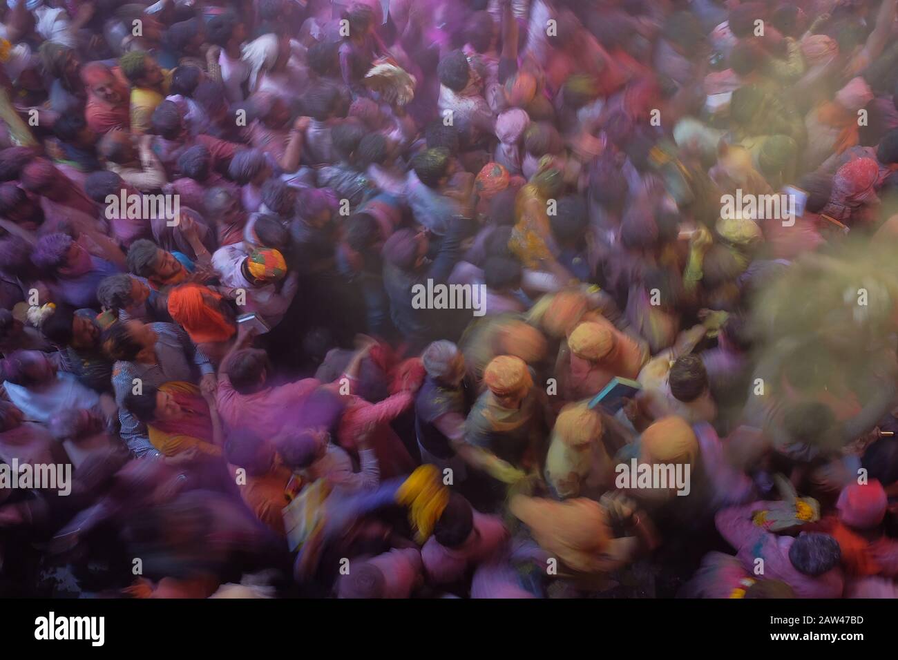 General view crowded during the Hindu Holi Festival in banke bihari temple vrindavan, India, on March 20, 2019. The Hindu Holi Festival takes place in India. The two-day celebration marks the victory of good over evil and marks the end of winter and the arrival of spring. Holi Festival celebrations are usually Indian residents playing water while throwing colorful powder. Stock Photo