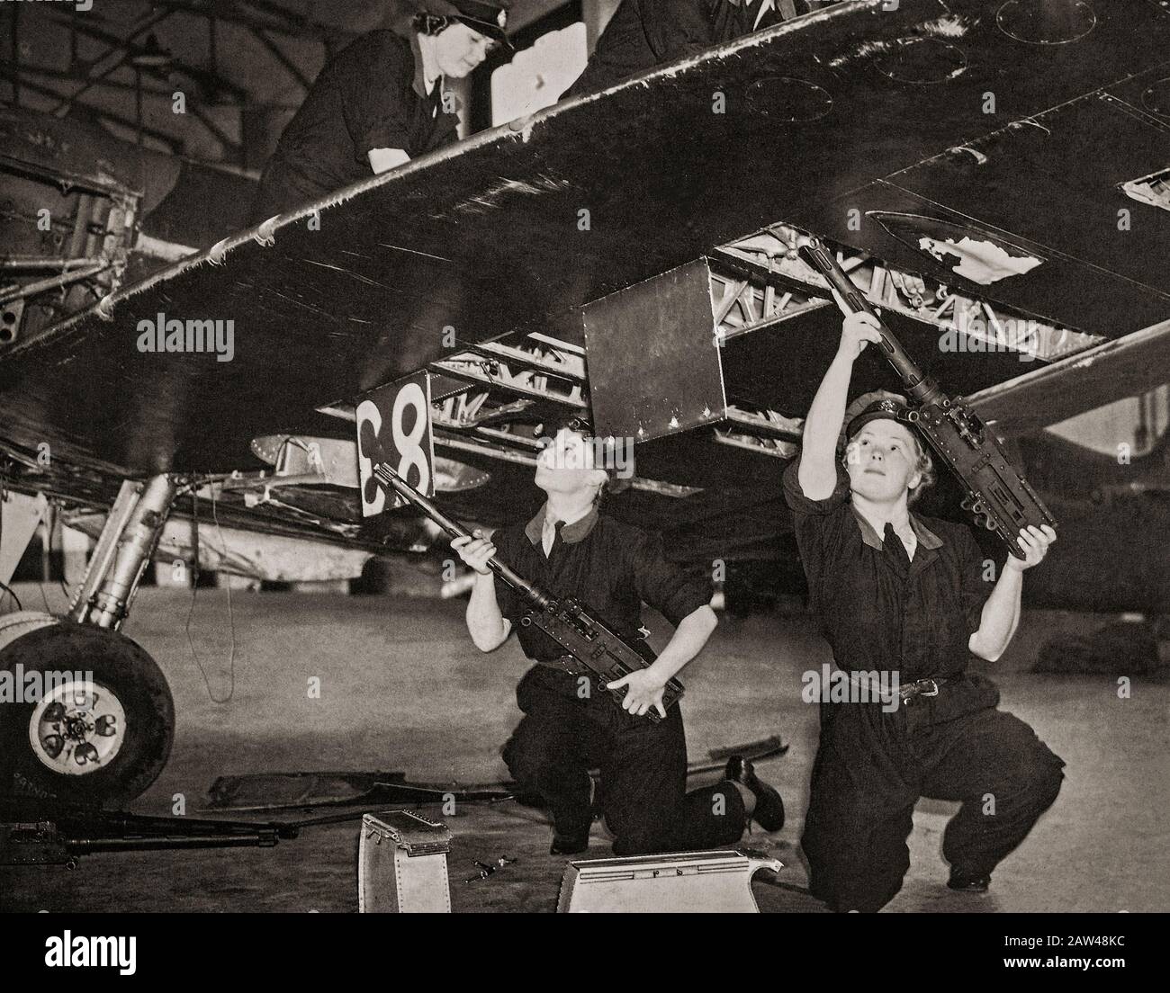Armourers of the WAAF installing Browning .303 inch Machine Guns in a Supermarine Spitfire. The WAAF (Women's Auxiliary Air Force) was created on 28 June 1939,  and women recruited into the WAAF were given basic training. WAAFs did not serve as aircrew, but were active in parachute packing and the crewing of barrage balloons in addition to performing catering, meteorology, radar, aircraft maintenance, transport, communications duties including wireless telephonic and telegraphic operation. Stock Photo