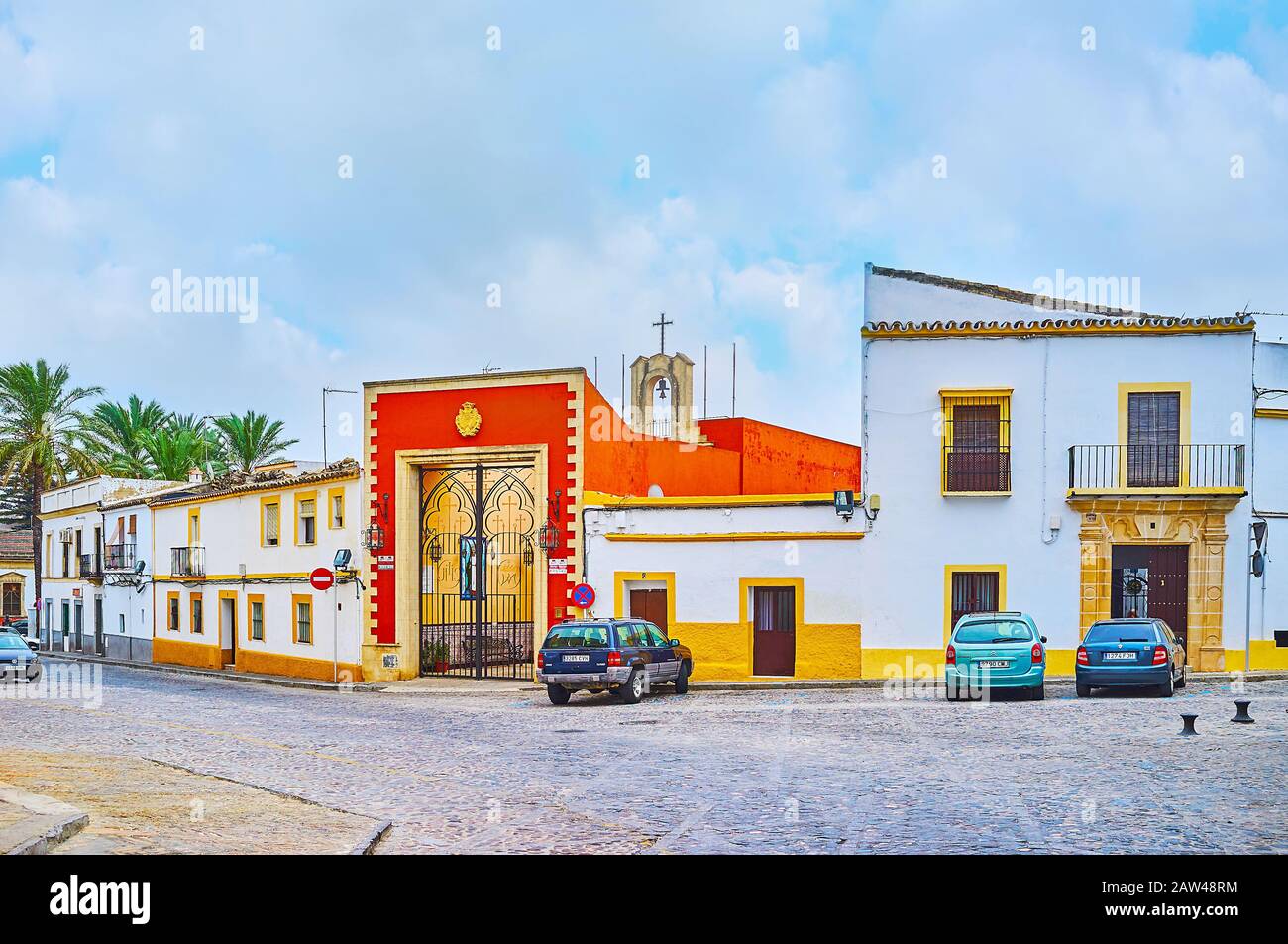 JEREZ, SPAIN - SEPTEMBER 20, 2019: The bright red gate of Santa Marta Chapel, located in San Mateo Square of old town, on September 20 in Jerez Stock Photo