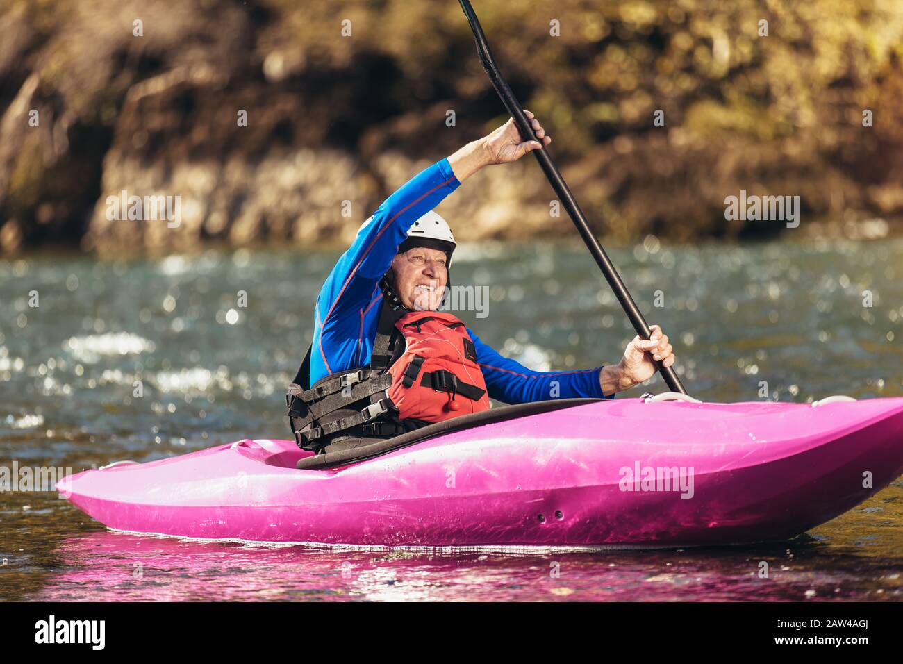 Active senior man paddling kayak. Gray hair man enjoy river kayaking. Stock Photo