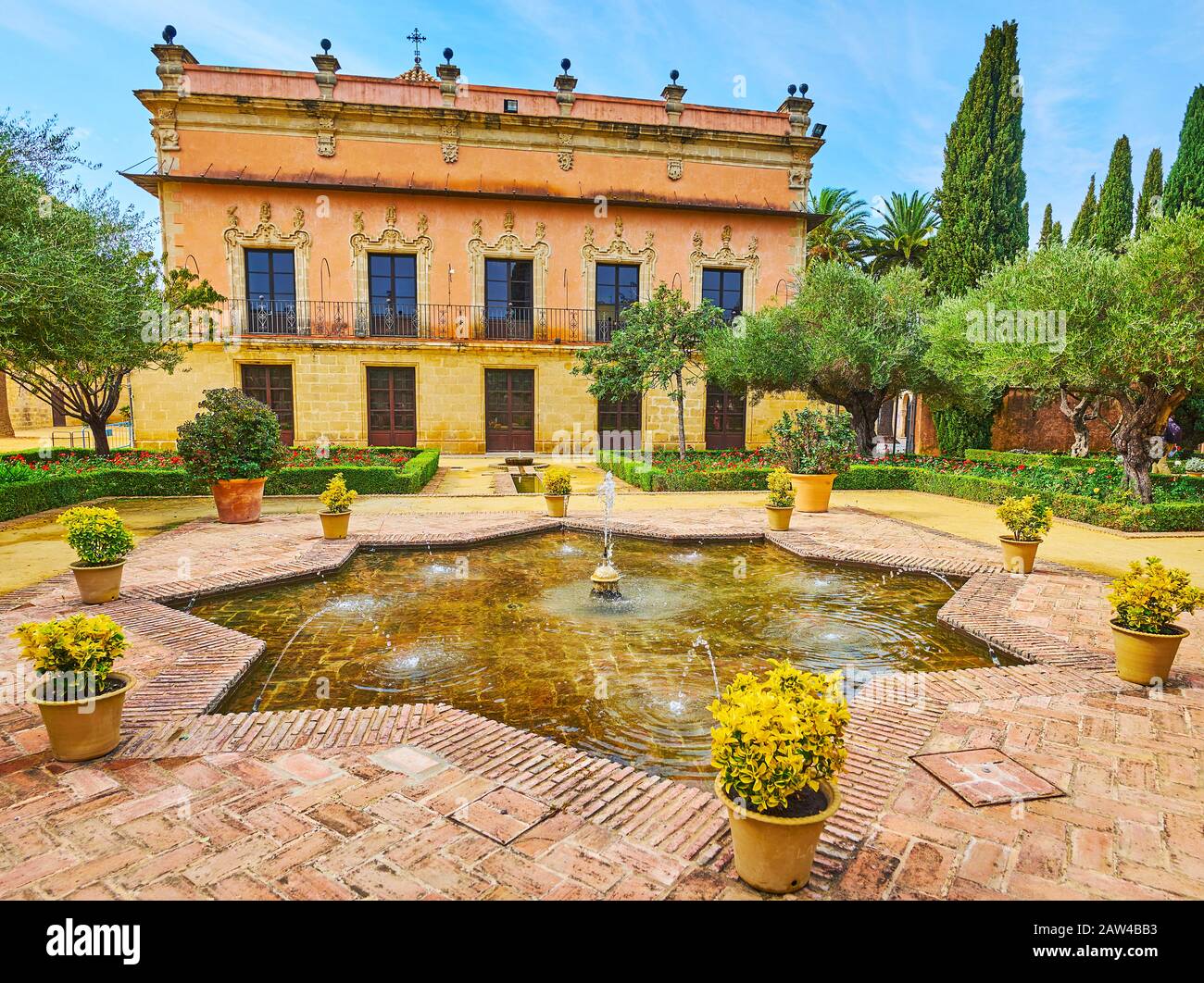 The old fountain in Andalusian garden of Alcazar in front of