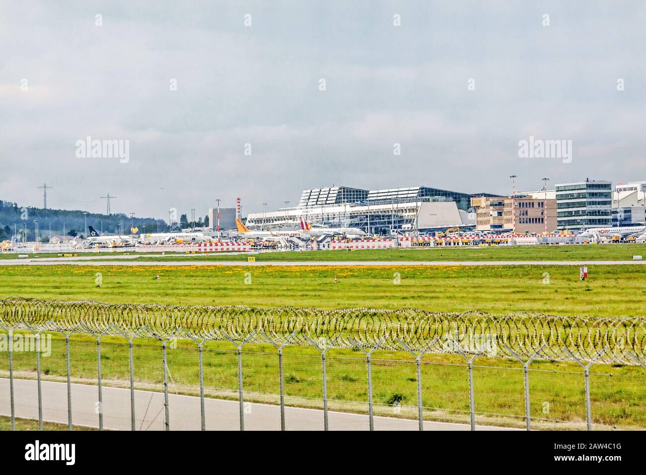 Stuttgart, Germany - May 06, 2017: Airport Stuttgart (Manfred-Rommel-Flughafen), Terminal, exterior view with airplanes in parking position, runway in Stock Photo