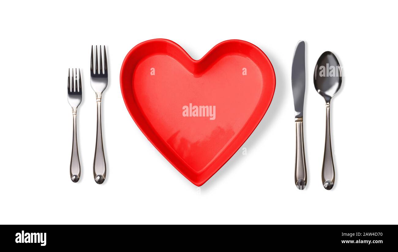 heart shape plate ,spoons ,forks, knife on white background Stock Photo
