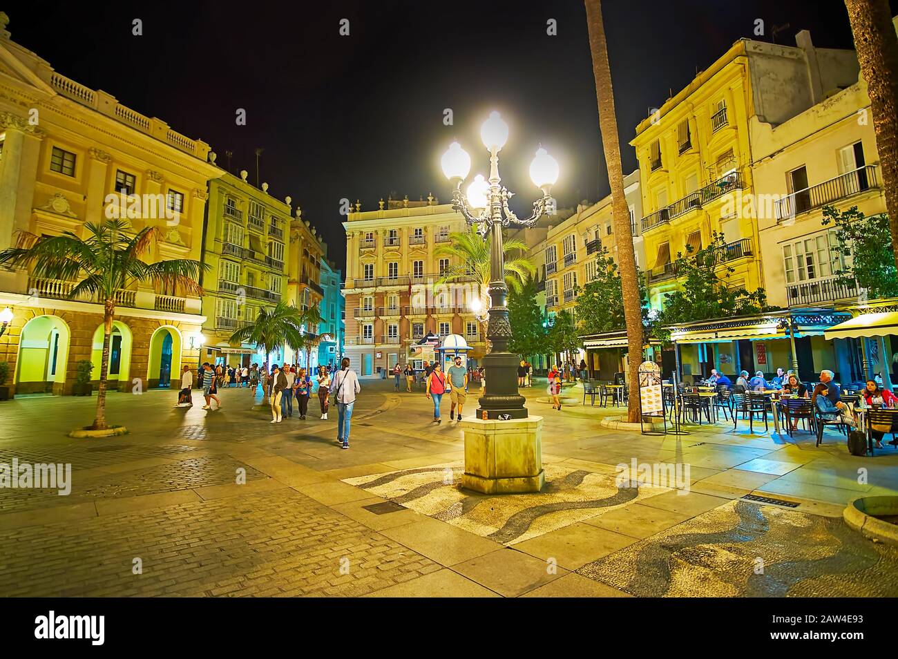 CADIZ, SPAIN - SEPTEMBER 20, 2019: The evening view of Plaza de San Juan de Dios square with vintage streetlight and Pazos Miranda House on the backgr Stock Photo