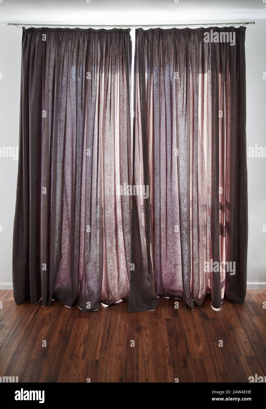 Closed dark curtain in modern apartment with wooden floor Stock Photo