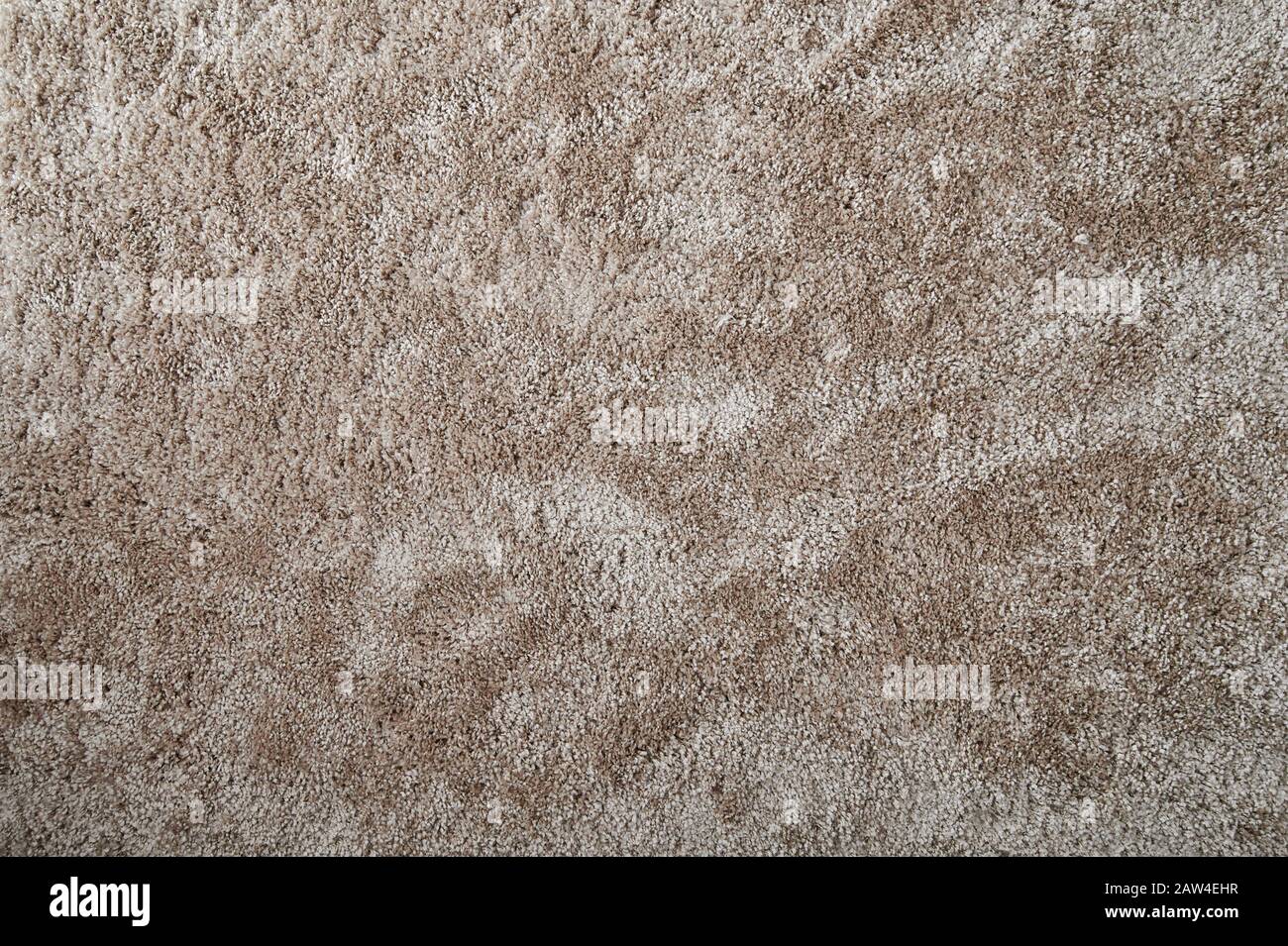 Cozy fluffy brown carpet surface pattern. Clean fabric rug Stock Photo