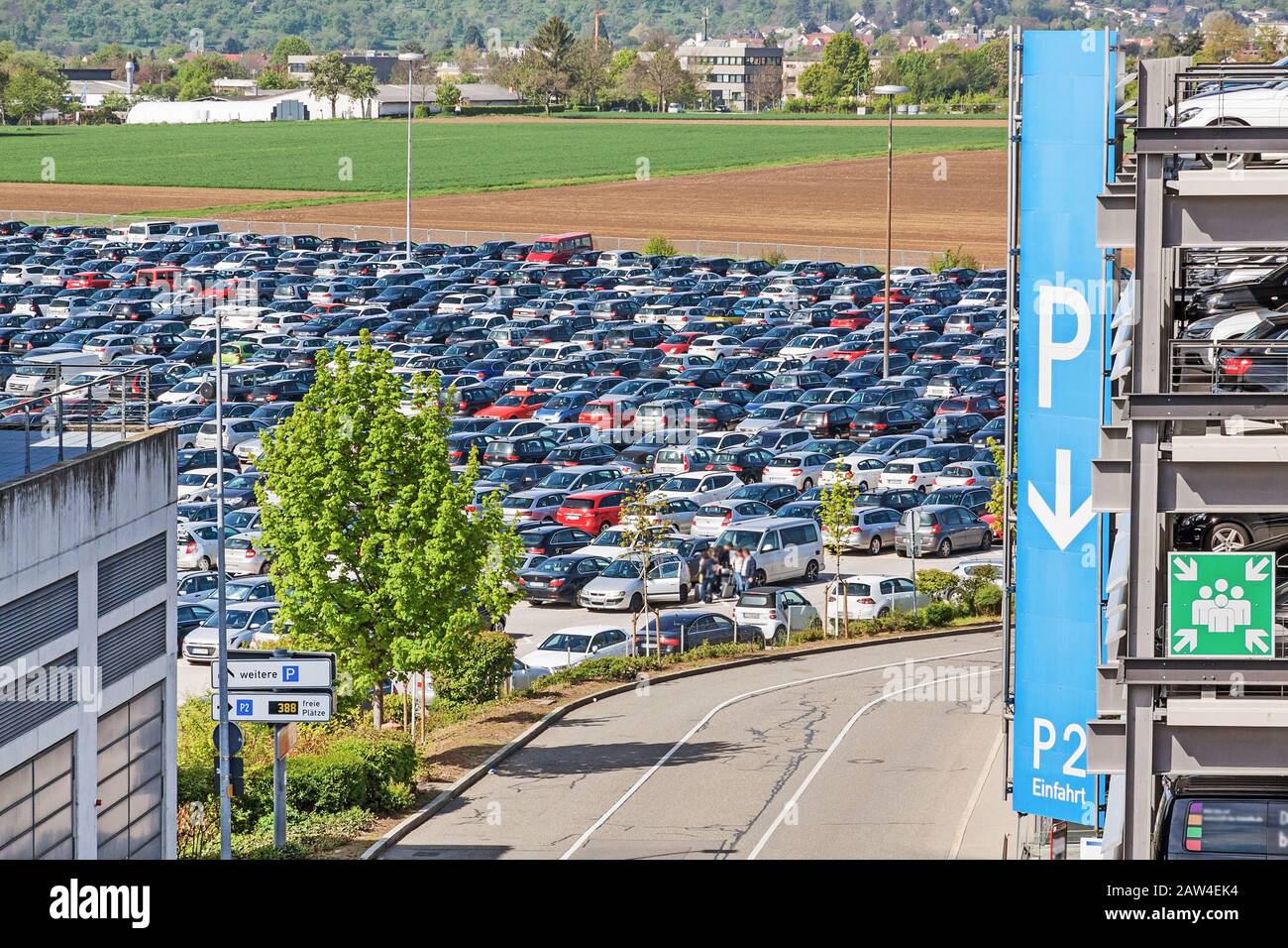 Airport parking lot with cars - parking garage with P sign aside Stock Photo