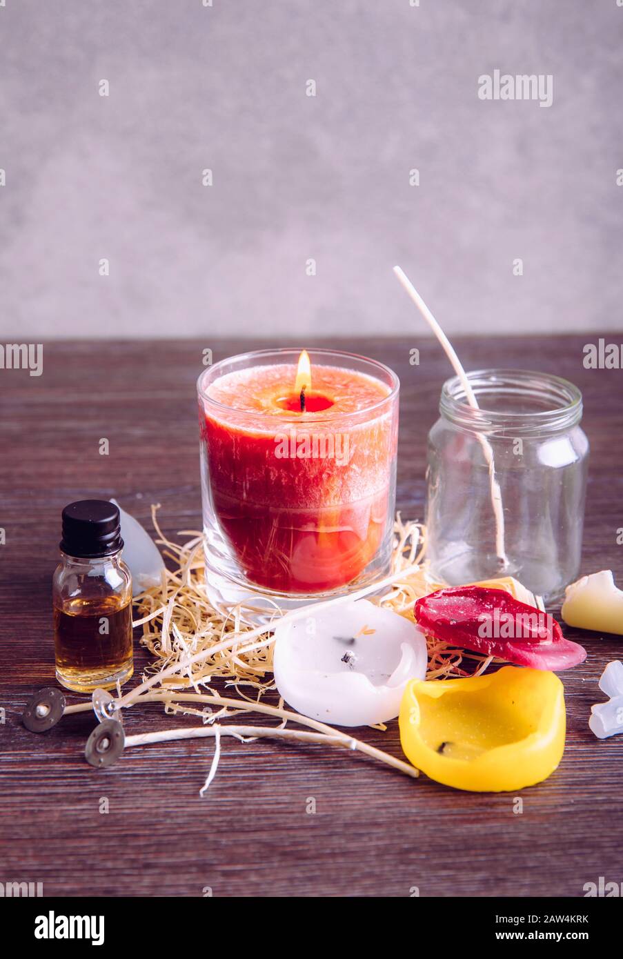 Reusing old candles leftovers and making melting a new one: various  ingredients on table: candle wicks, glass jar, old candles wax, aroma oil.  New can Stock Photo - Alamy