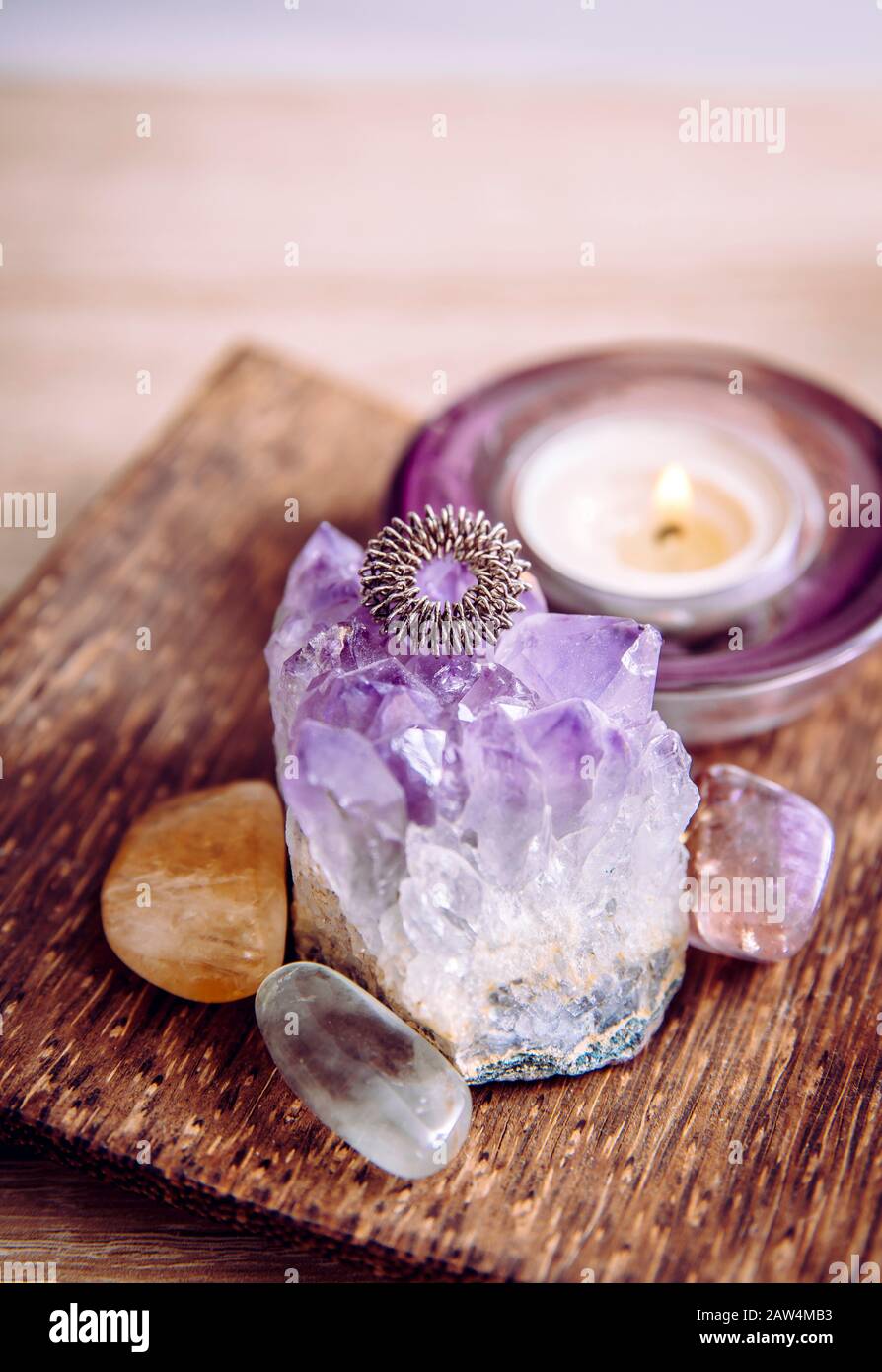 Acupressure massage ring on amethyst crystal cluster. Acupressure is an alternative medicine technique with physical pressure is applied to acupunctur Stock Photo