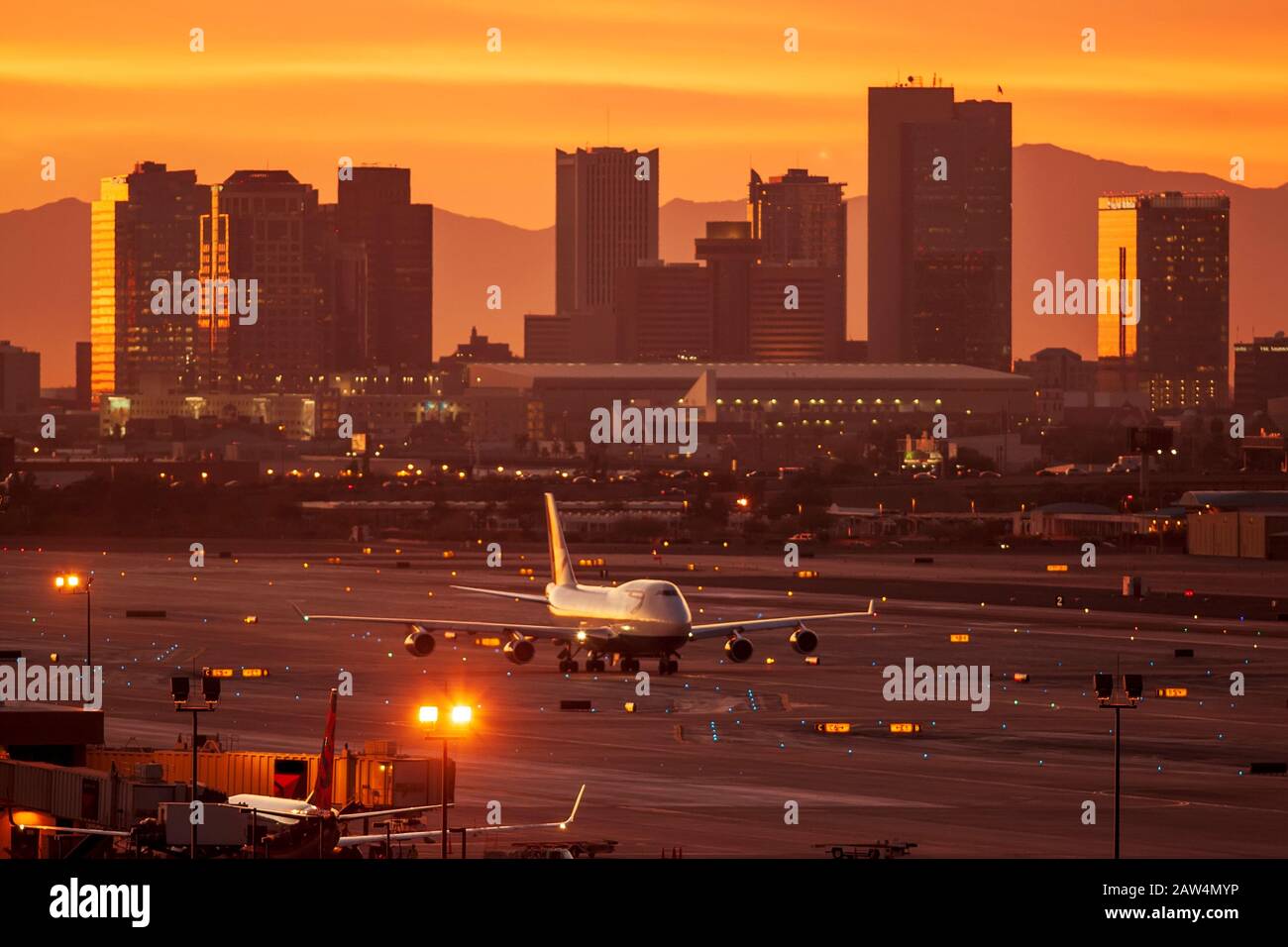 747 jet taxiing on the runway at sunset. Sky Harbor Int. Airport. Phoenix, Arizona. Stock Photo