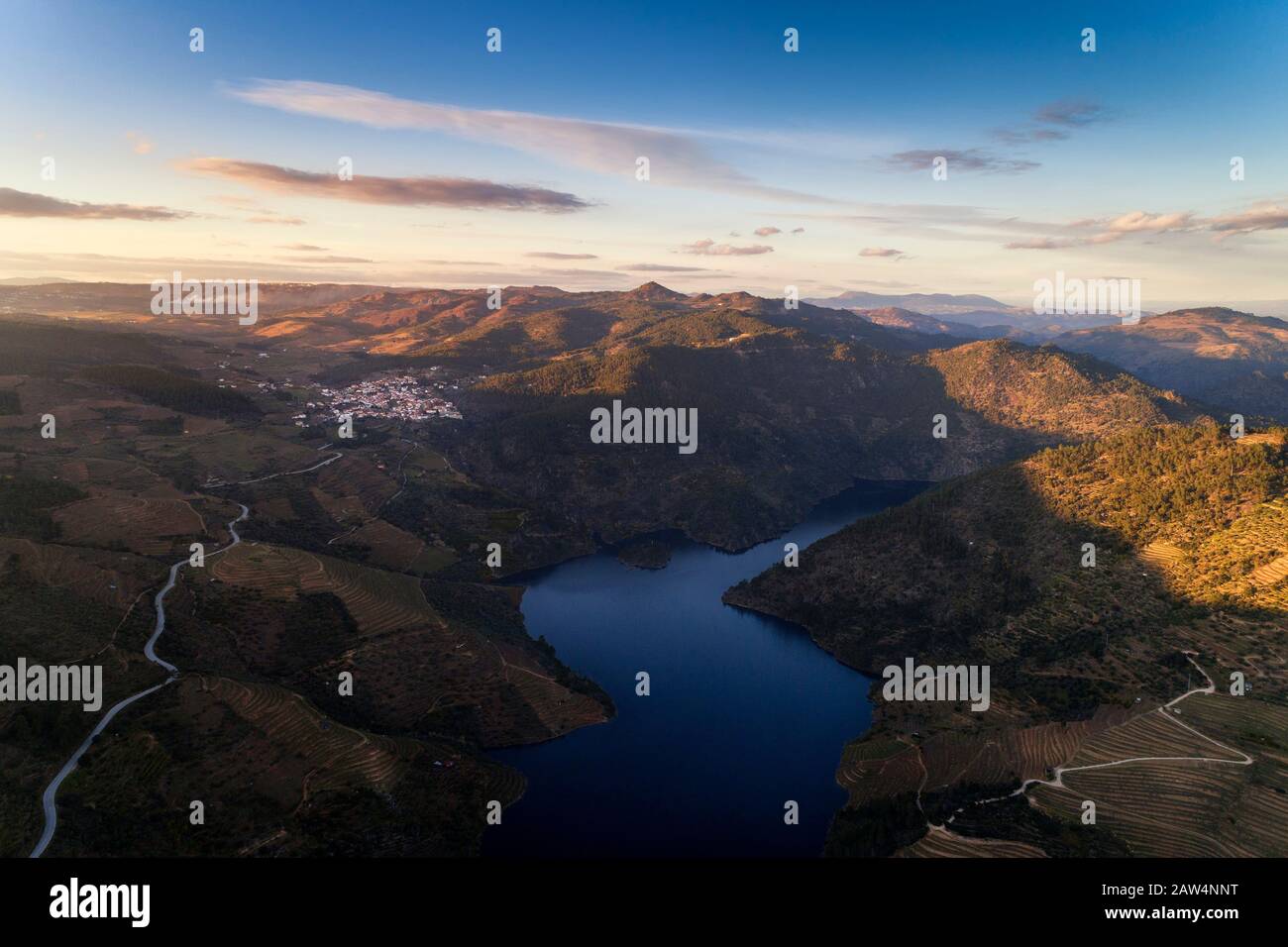 Aerial view of the Douro Valley, with the terraced vineyards, the Tua River and the village of Sao Mamede de Ribatua, in Vila Real, Portugal; Concept Stock Photo