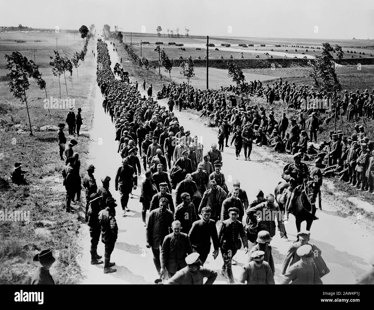 Long Line of Captured German Soldiers, Prisoners of War, walking along Road, France, 1916-1918 Stock Photo