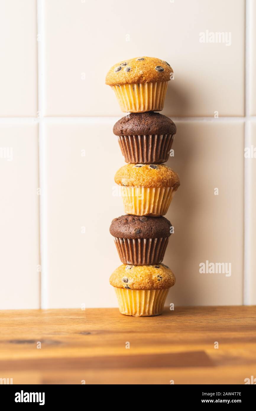 Sweet muffins. Chocolate cupcakes on kitchen table. Stock Photo