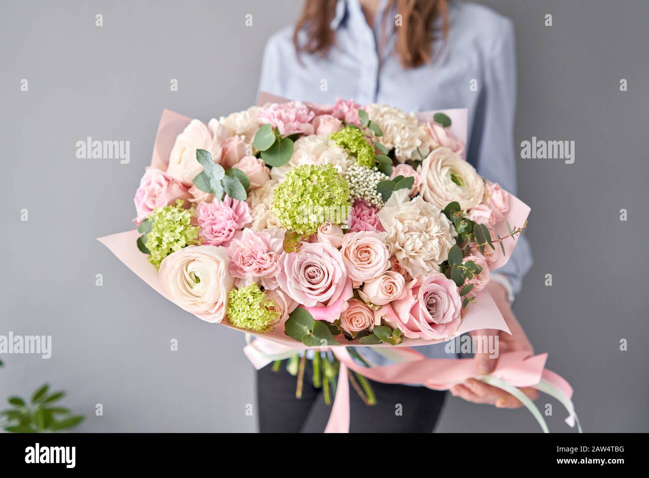 European floral shop. Beautiful bouquet of mixed flowers in womans