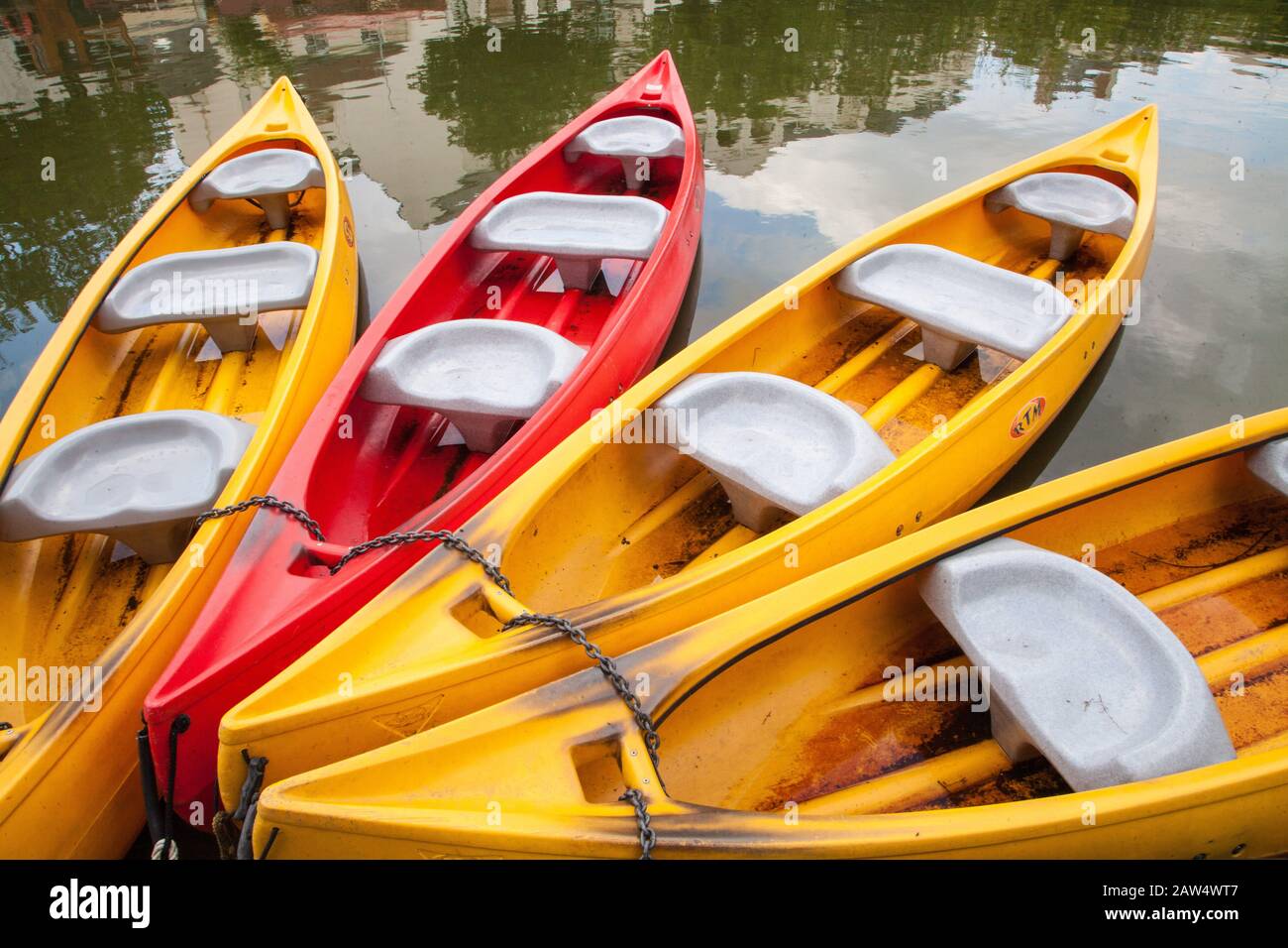 colorful canoes floating together waiting for someone to use them Stock ...