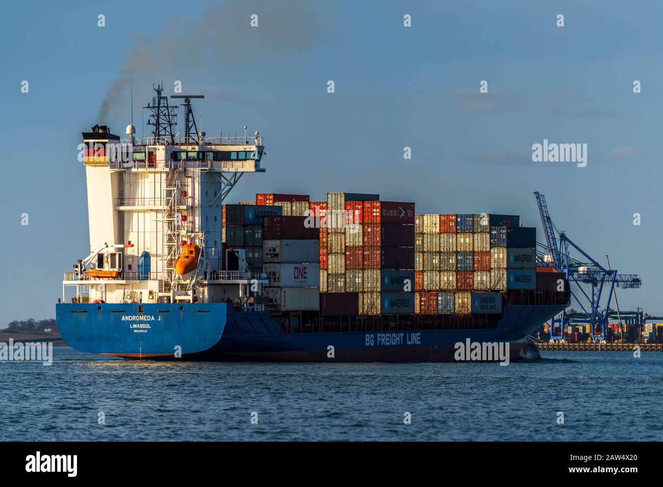 Andromeda J Feeder Vessel - Cypriot registered container feeder ship Andromeda J enters Felixstowe Port with its load of containers. Stock Photo