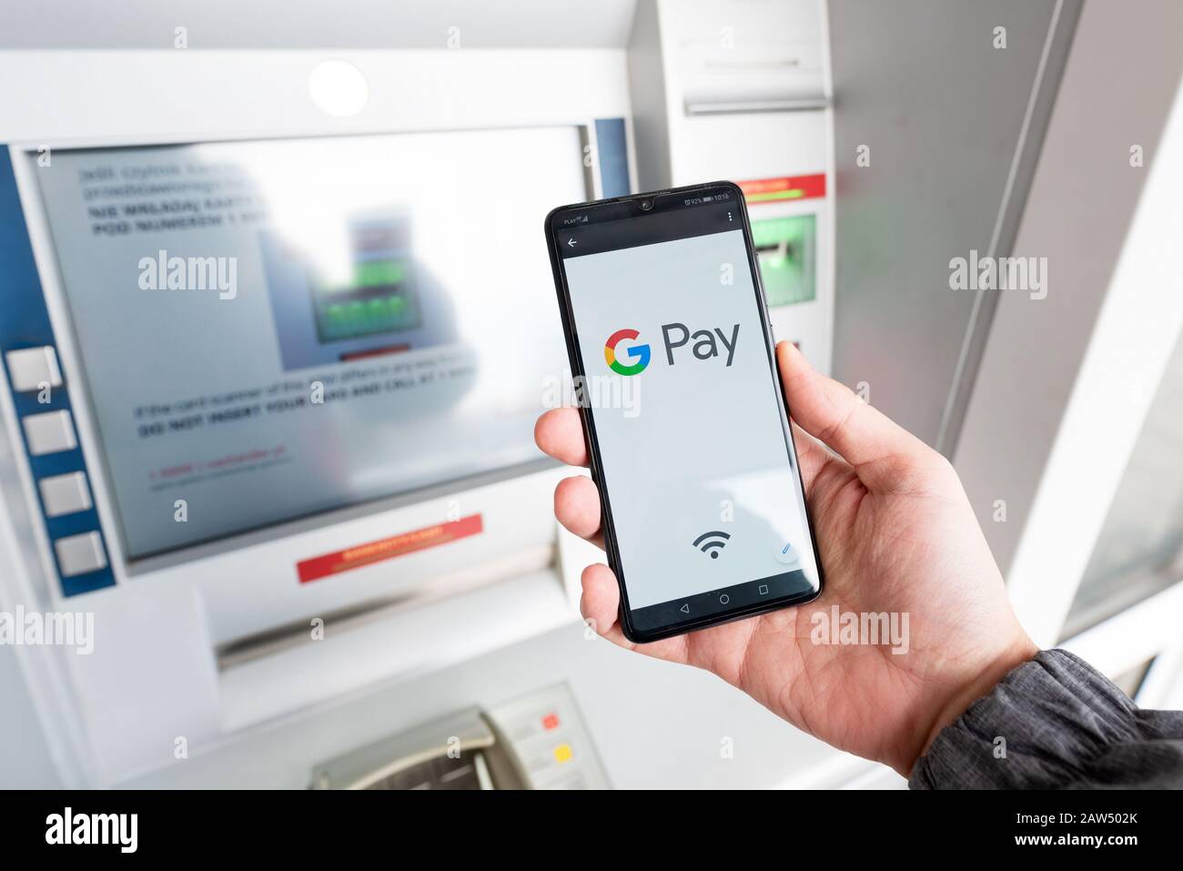 Wroclaw, Poland - NOV 06, 2019: Man holding smartphone with Google Pay logo. Google Pay is electronic wallet developed by Google. Stock Photo