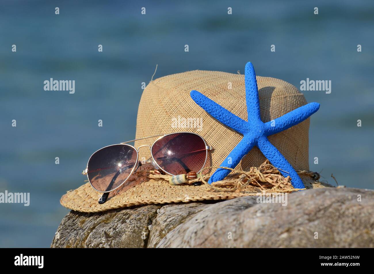 Summer vacation concept, straw hat, sunglasses and blue starfish on a ...