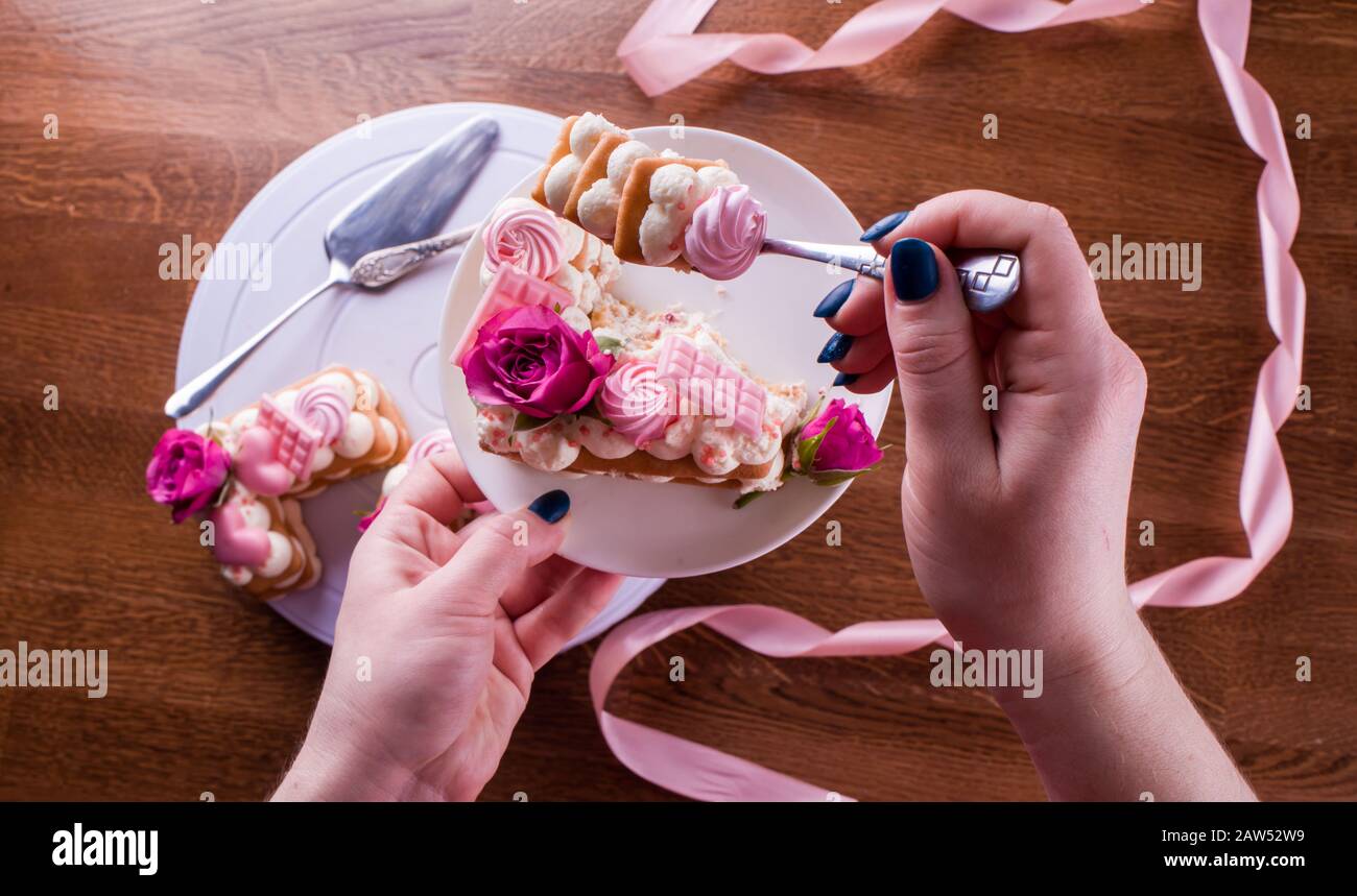 The hands of the confectioner with a delicate and delicious cake of ...