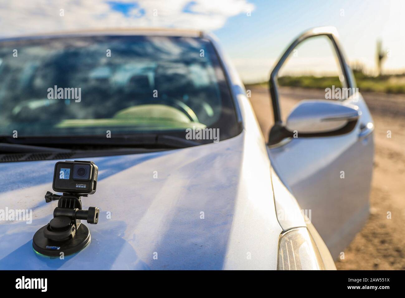 Kia Forte and GoPro action camera in the desert of Sonora Mexico. White car  on dirt road. travel outdoors..Sonora desert. Kia Forte y camara de accion  GoPro en el desierto de Sonora