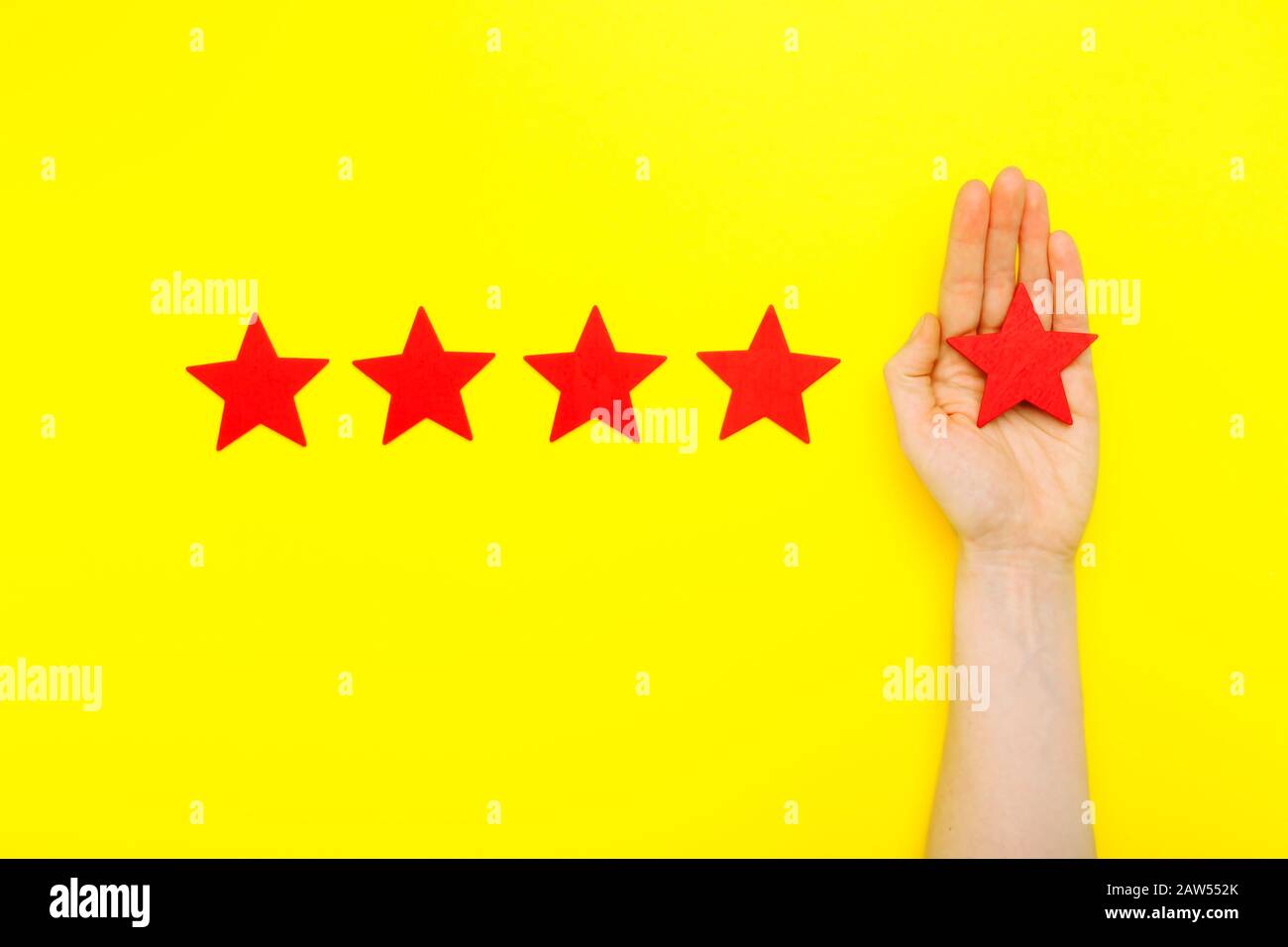 5 stars increase rating, customer experience concept. Hand of client show putting 5 star symbol to increase Service rating. five red stars excellent Stock Photo