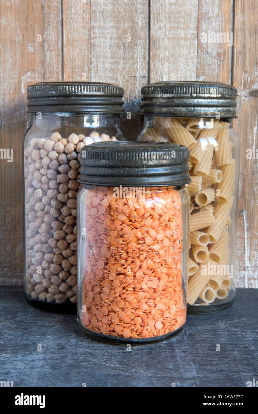 Vintage Kilner glass storage food jars with metal lids containing red  lentils, chickpeas and pasta against wood background in kitchen. Vegaterian  , vegan, zero waste concept Stock Photo - Alamy