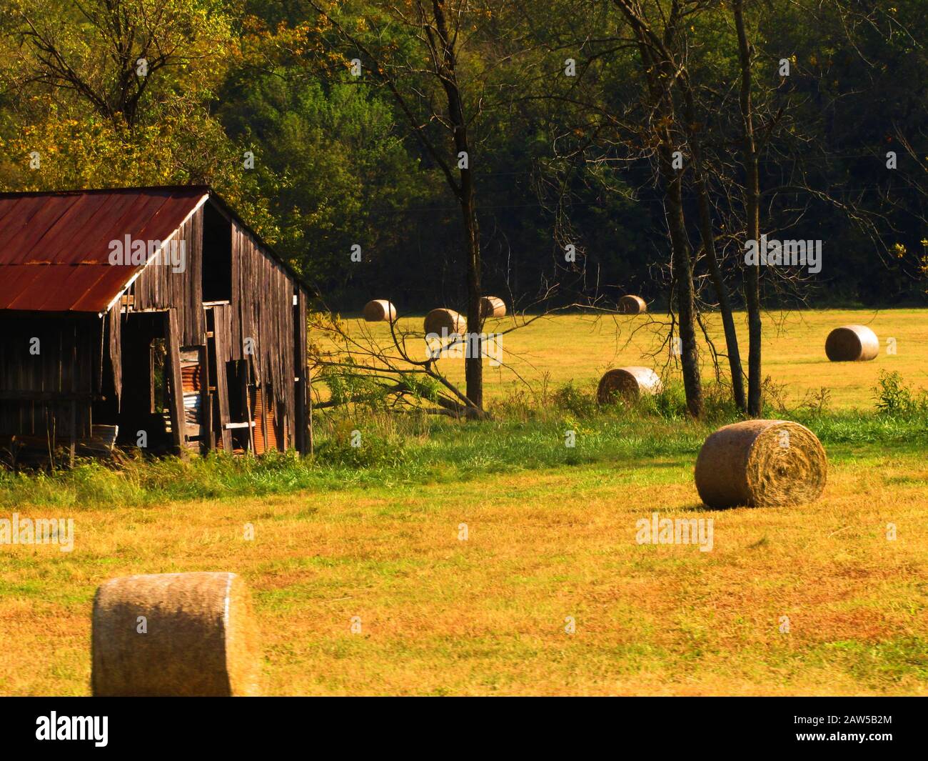An old barn near some hay bales Stock Photo