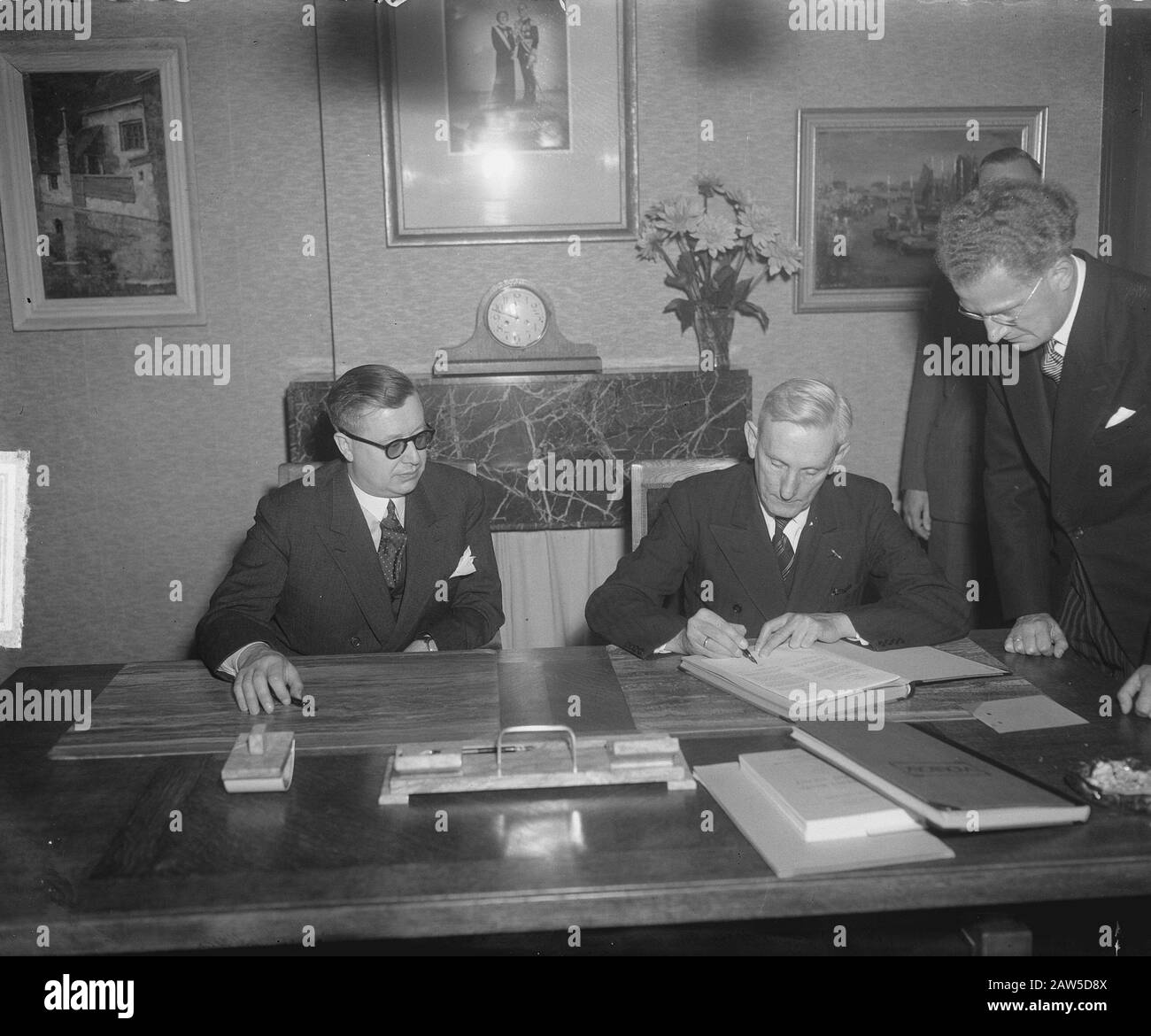 Signature at the Ministry of Social Affairs by the Belgian Minister Eli Troclet Leon (left) and the Dutch Minister Mr A.M.. Joekes (right) of the Treaty of Social Insurance. Minister Joekes signs. Date: June 23, 1949 Location: The Hague, South Holland Keywords: Ministers, signing treaties Person Name: Joekes AM Troclet, Leon Eli Stock Photo