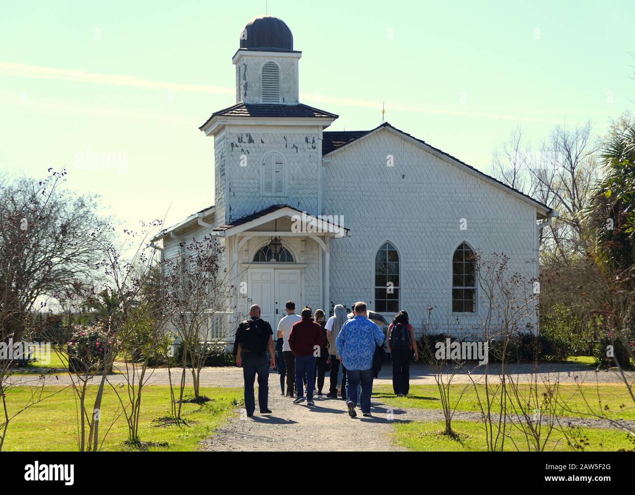 Edgard, Louisiana, U.S.A - February 2, 2020 - Visitors in front of the white church near Whitney Plantation Stock Photo
