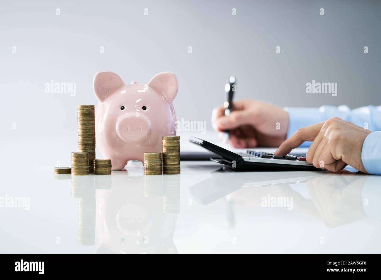 Man Calculating Savings And Costs. Side View Stock Photo