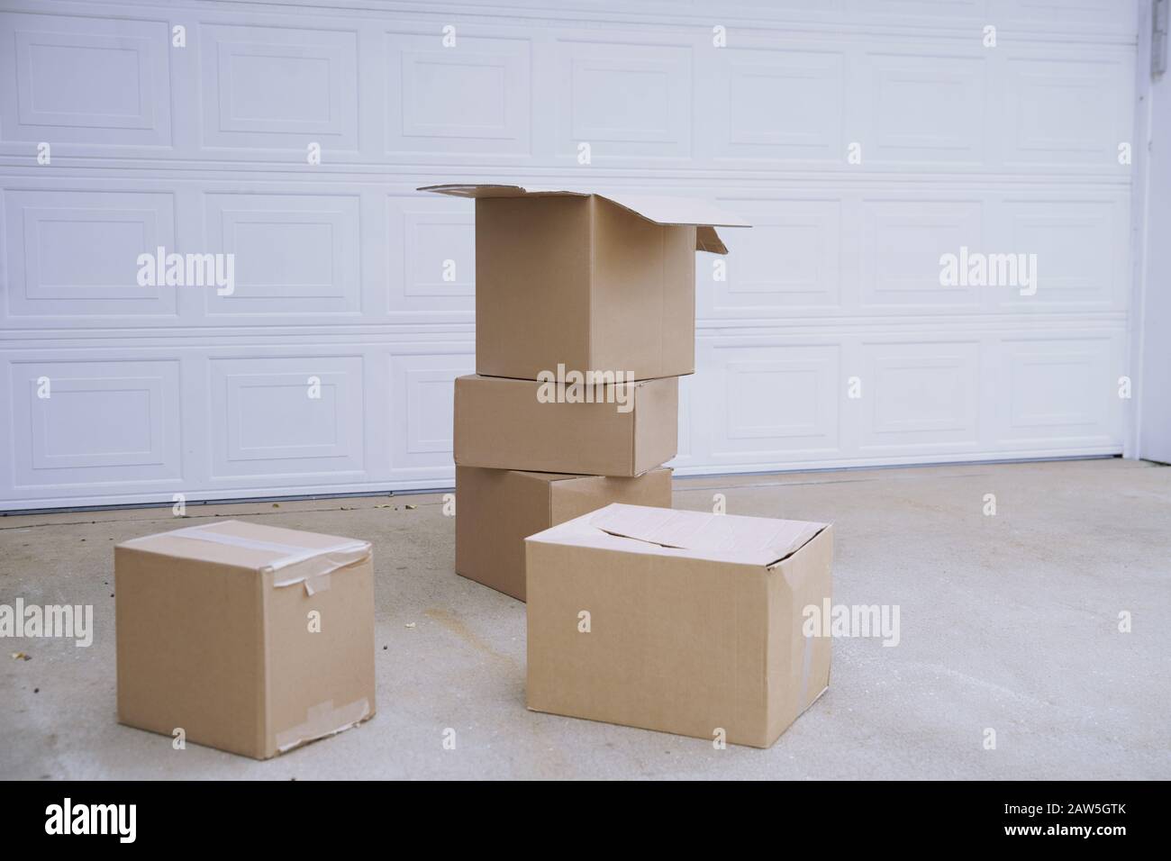 Cardboard boxes at the garage door Stock Photo Alamy