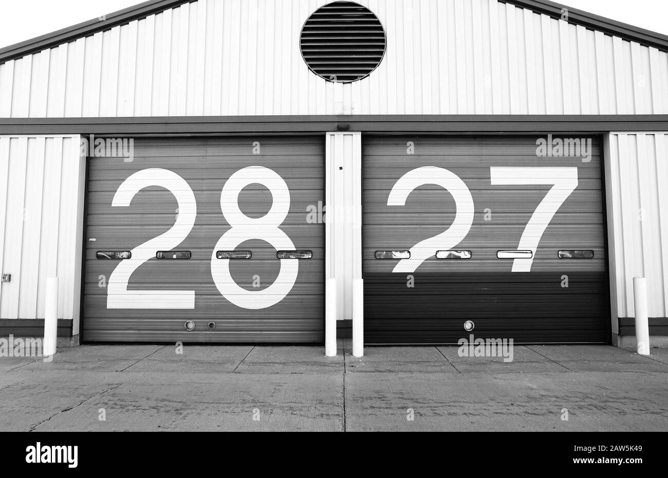 bus-garage-doors-with-the-numbers-28-and-27-on-the-doors-2AW5K49.jpg