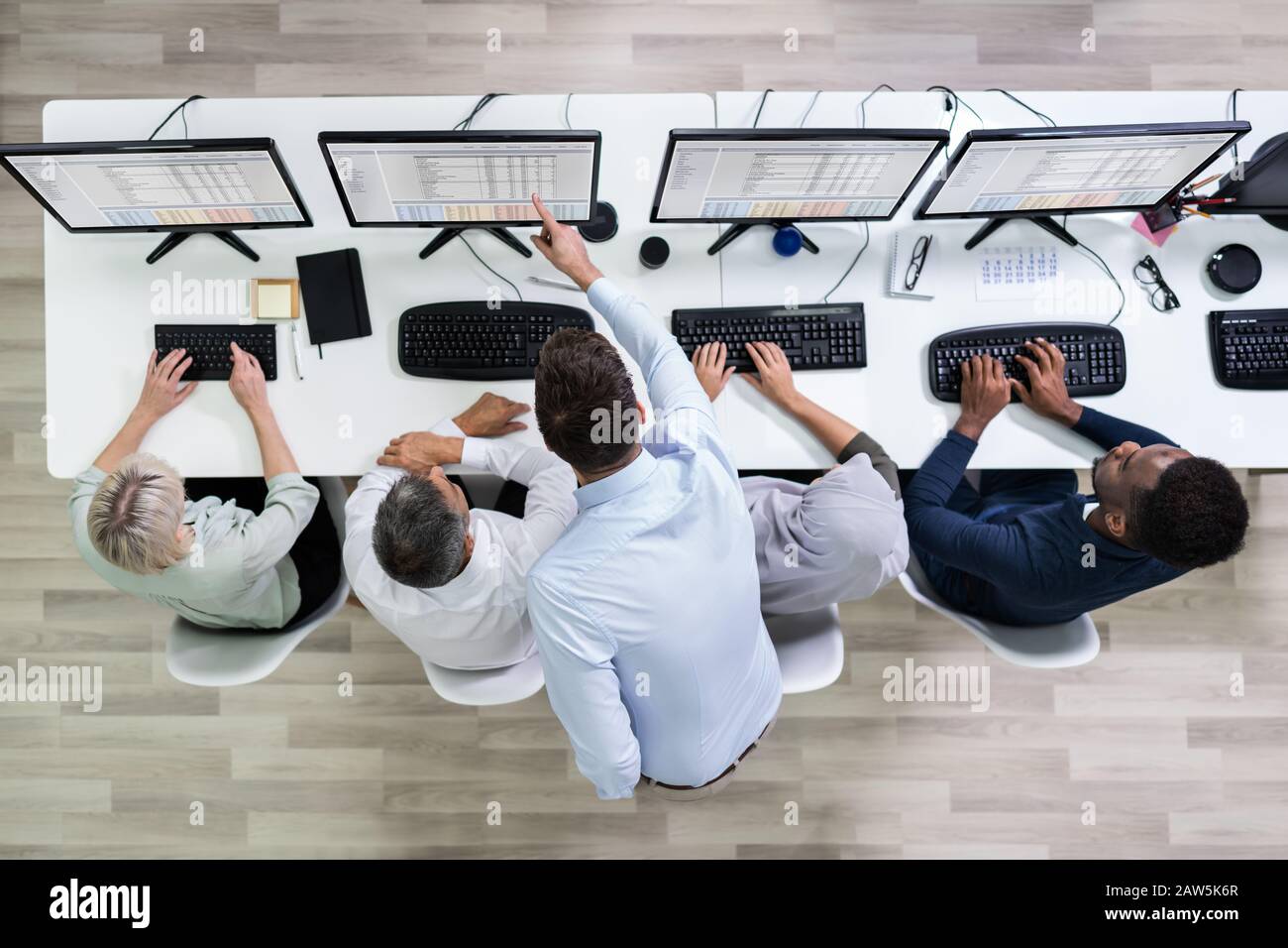Elevated View Of Team Leader Giving Training To Her Call Center