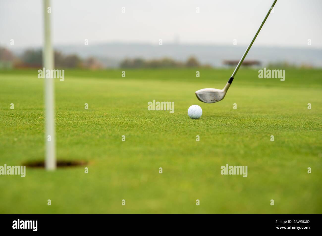 golf game on green course with ball and stick Stock Photo