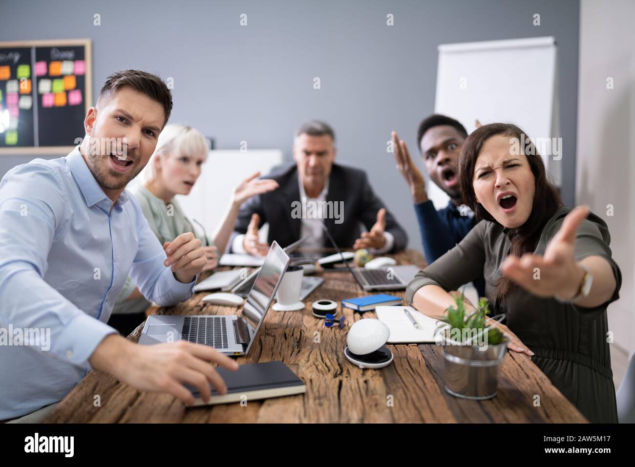 Group Of Business Executives Complaining Toward Camera In Office Stock Photo