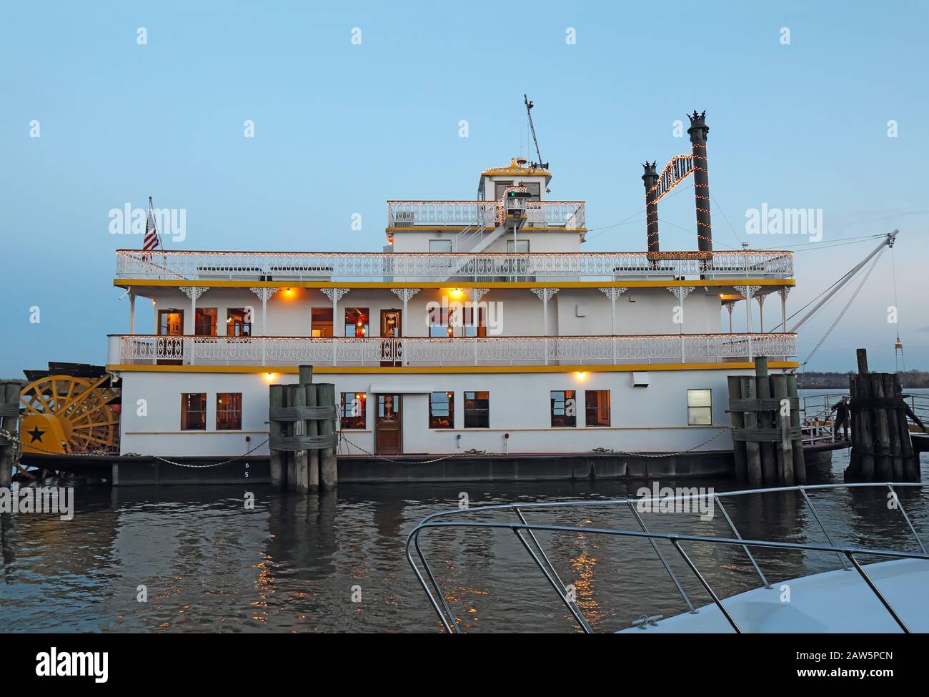 A paddlewheel boat at the waterfront of Alexandria, Virginia at sunset Stock Photo