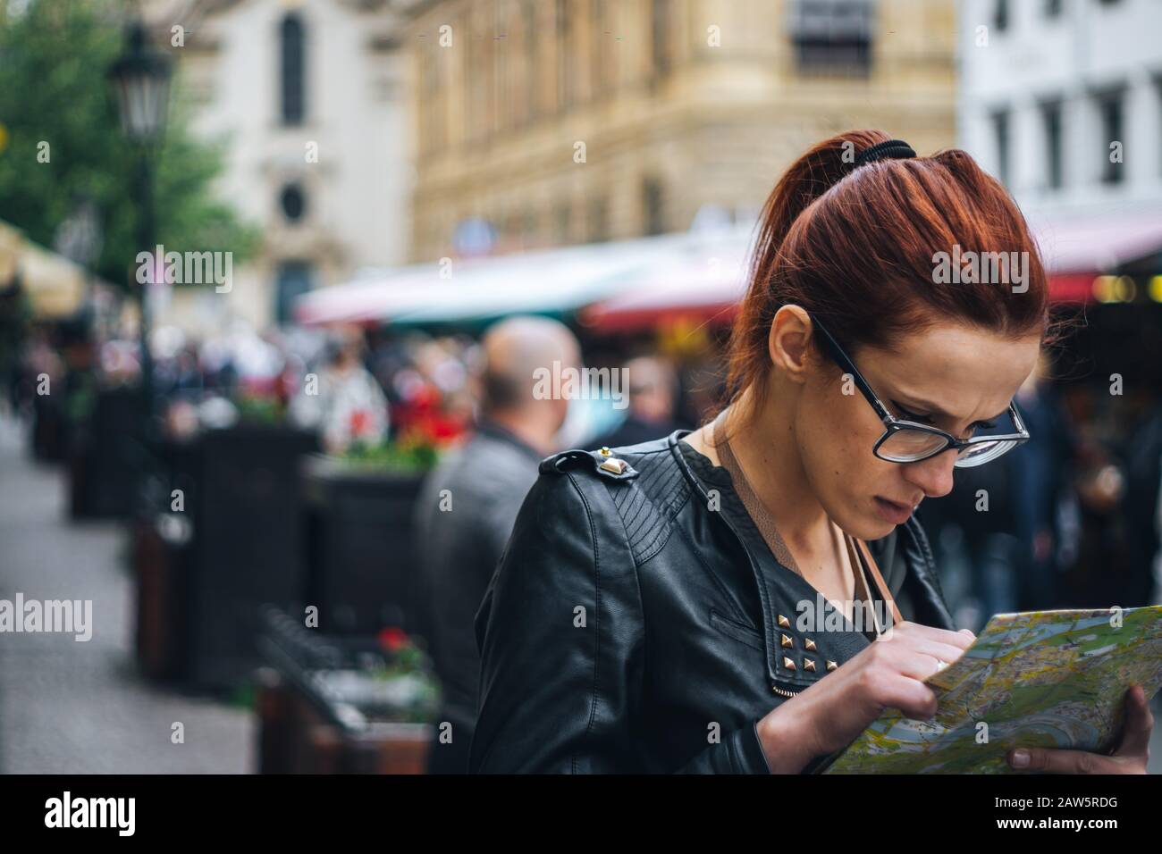 Girl is looking for directions in city of Prague Stock Photo