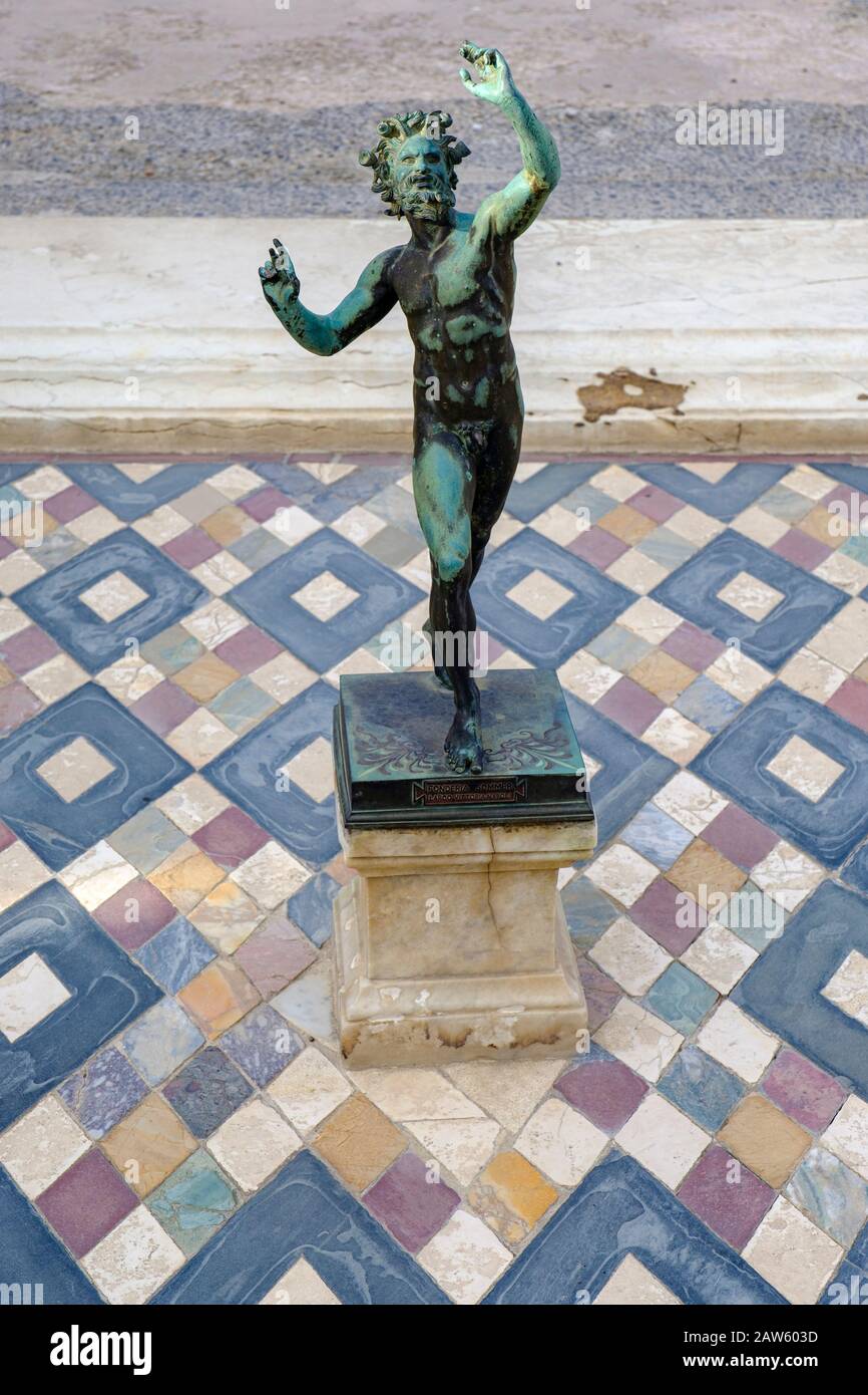 Pompeii ruins, Dancing Faun, Satyr bronze statue replica, House of the Faun atrium, Casa del Fauno tablinum, ancient city of Pompeii, Italy, Europe Stock Photo