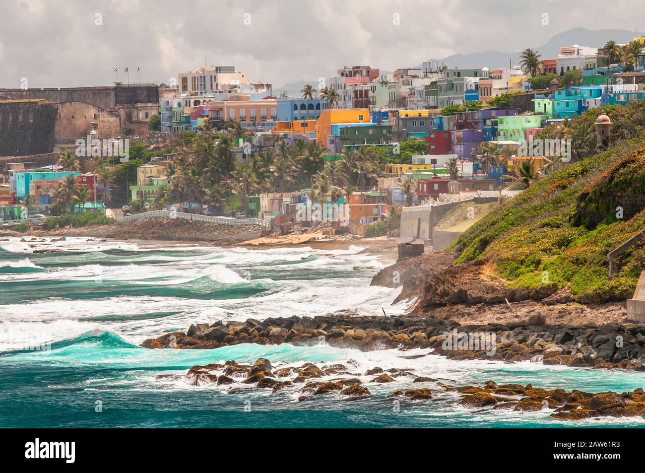 Colorful houses line the hillside over looking the beach in San Juan, Puerto Rico. Stock Photo