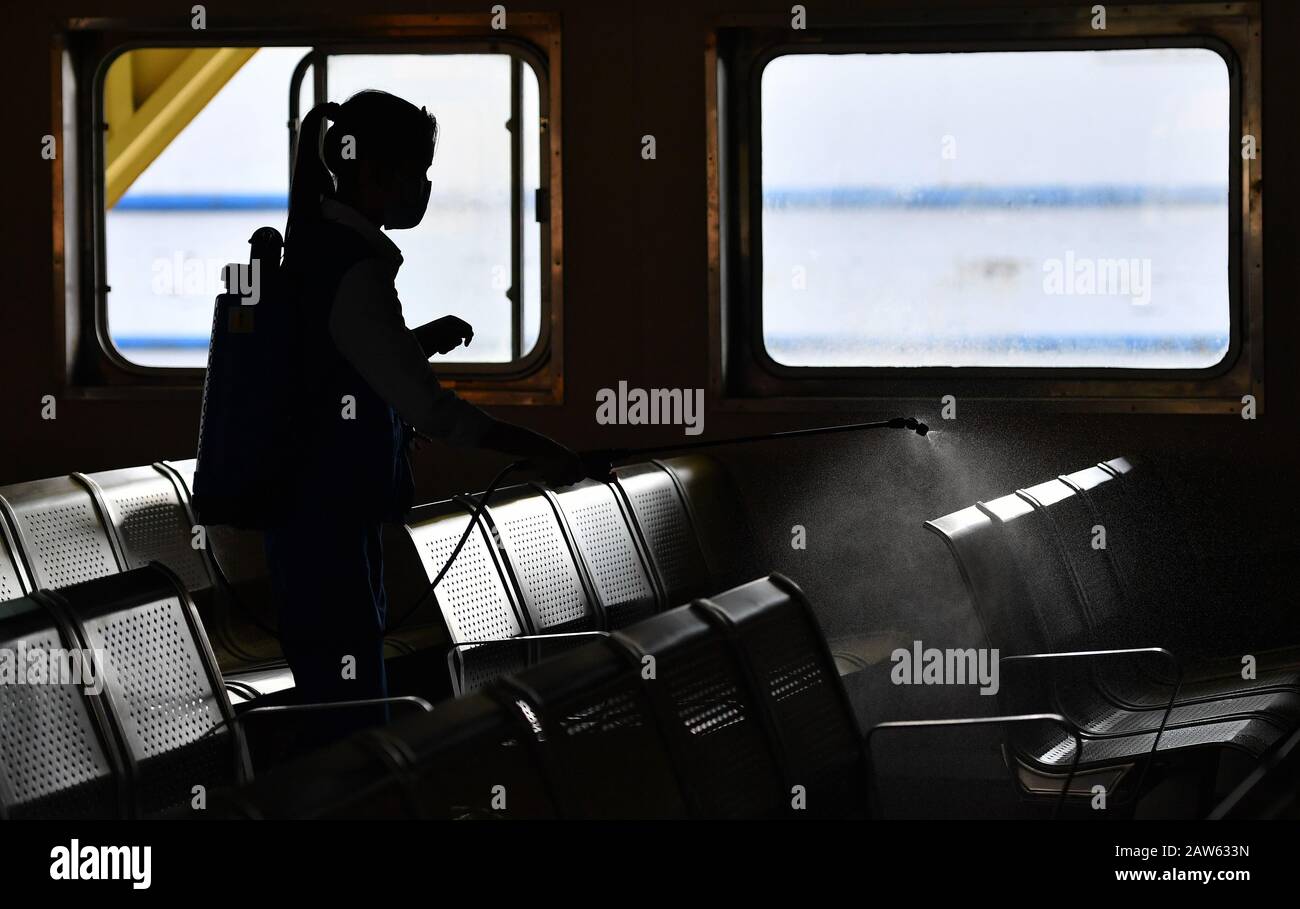 (200207) -- HAIKOU, Feb. 7, 2020 (Xinhua) -- A staff member disinfects the interior of a ferry in Zhanjiang, south China's Guangdong Province, Feb. 6, 2020. Qiongzhou Strait is a major passage into and out of Hainan Island. Since the start of the prevention and control of pneumonia caused by the novel coronavirus, Hainan and Guangdong have both moved the prevention and control threshold forward. Hainan has sent more than 160 joint anti-epidemic personnel from multiple departments to Zhanjiang of Guangdong Province, and set up four prevention and control points and an observation point there.In Stock Photo